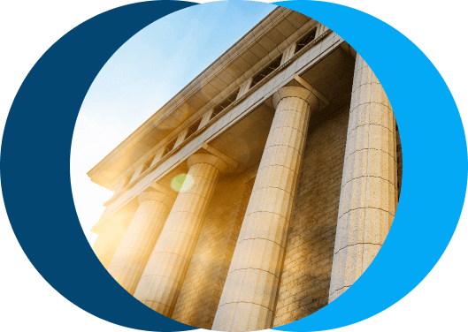 Low-angle view of a professional court building with stone columns, symbolizing High Court enforcement authority
